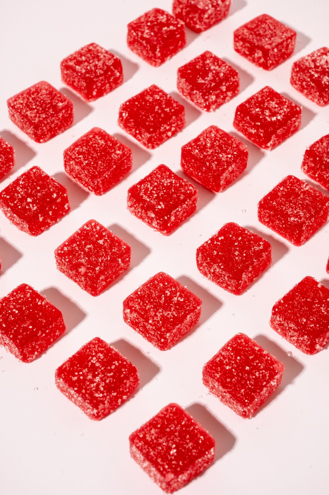 Rows of sugar-dusted strawberry gummies